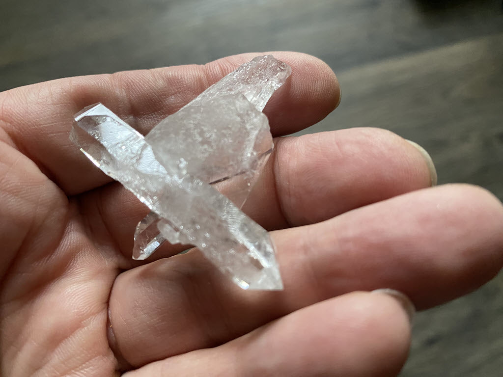 Double-terminated clear quartz crystals clustered together in this beautiful natural cross from Corinto, in Brazil. This is one piece of a small collection